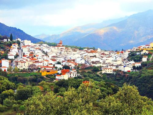 a town on a hill with mountains in the background at XXIX Casa El Balcón in Cortes de la Frontera