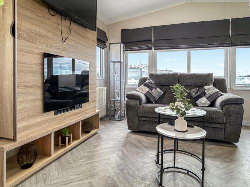 a living room with a couch and a tv at Coastal Bay View in Ayr