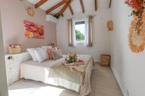 a bedroom with a bed with flowers on it at L Échappée Belle Havre de paix au cœur du verger in Le Moule