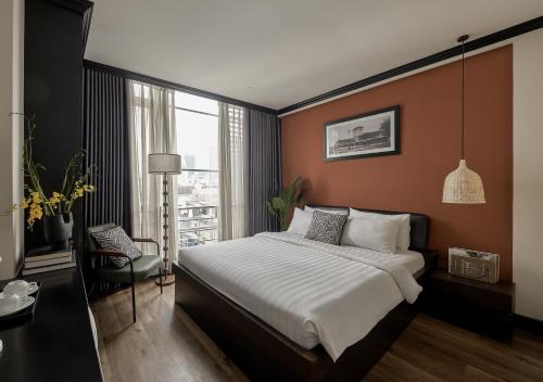 a bedroom with a large bed and a window at The One Premium Hotel - 1 Minute to Ben Thanh Market in Ho Chi Minh City