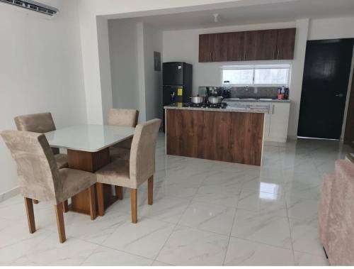 a kitchen with a table and chairs in a room at Welcome to your perfect Manta Coast getaway in Manta