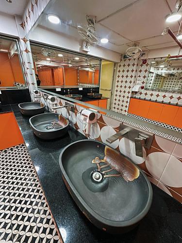 a bathroom with a sink and a row of toilets at Amango Home Brand 5 in Ho Chi Minh City