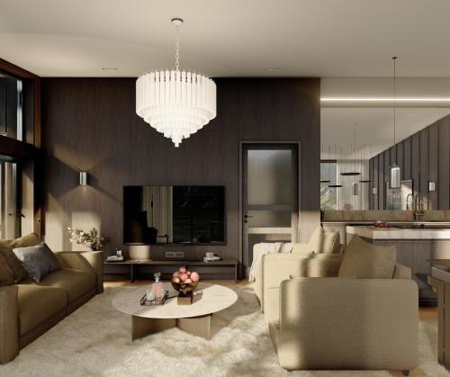 a living room with a couch and a chandelier at Fredvang Lodge, Lofoten in Hovdan