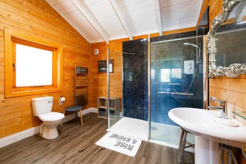 a bathroom with a shower and a toilet and a sink at Beautiful 3-Bed Luxury Private Lodge in York in York