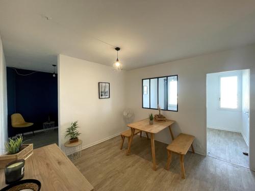 a living room with a table and a dining room at Leo Lagrange in Champforgeuil