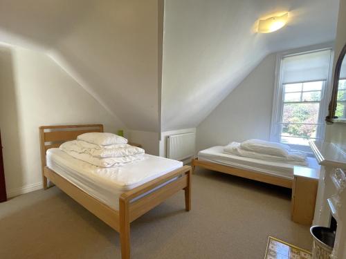 a bedroom with two beds and a window at Sterling House in Robin Hood's Bay