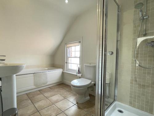 a bathroom with a toilet and a sink and a shower at Sterling House in Robin Hood's Bay