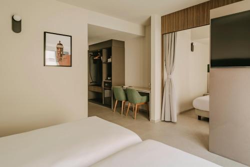 a hotel room with a bed and a desk at Regional Hotel by NEU Collective in Il-Gżira
