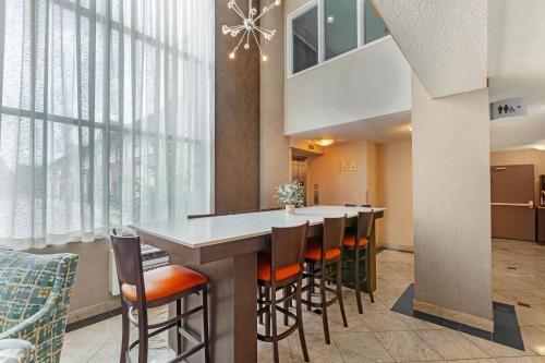 a kitchen with a table and chairs and a large window at Quality Inn & Suites 5585 Ambler Drive Mississauga Ontario in Mississauga