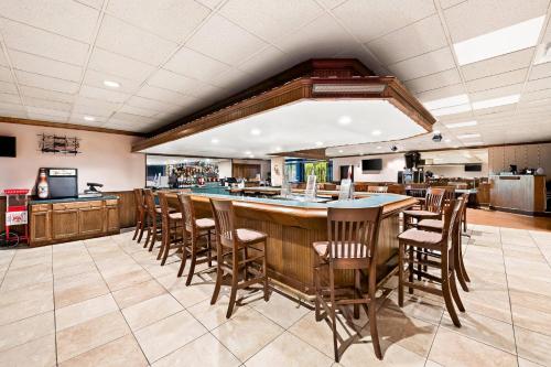 a bar in a restaurant with chairs and a counter at Quality Inn Dayton Airport in Englewood