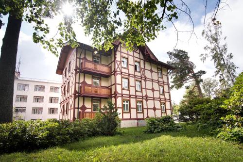 an old building in the middle of a park at Apartment Jelena1 in Tatranská Lomnica