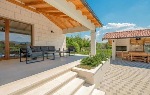 an outdoor patio with a table and chairs at Villa Modriola with heated pool in Donji Proložac - Imotski in Donji Proložac