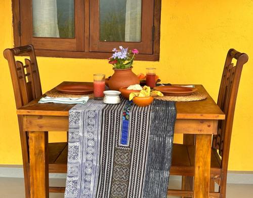 a wooden table with a vase on top of it at HAVEN-Your Private Mountain Sanctuary in Talatuoya