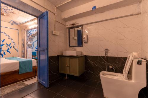 a bathroom with a sink and a toilet in a room at Storica Stays in Jodhpur