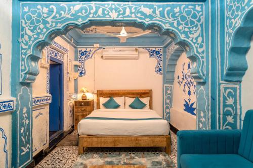 a bedroom with blue and white walls and a bed at Storica Stays in Jodhpur