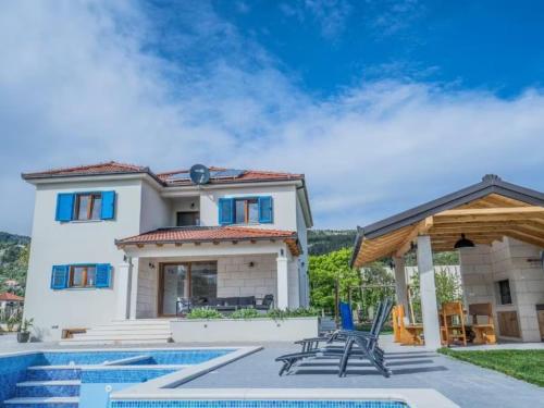 a villa with a swimming pool and a house at Villa Modriola with heated pool in Donji Proložac - Imotski in Donji Proložac