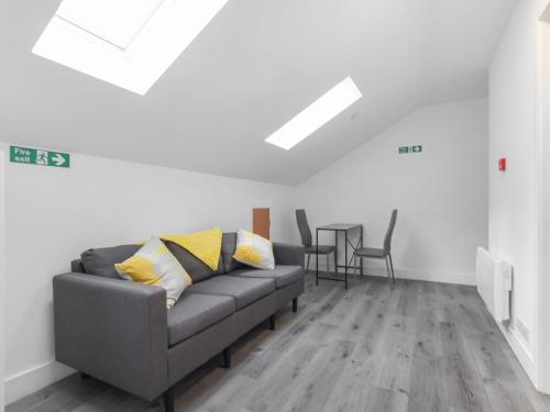a living room with a couch and a table at Room 1 At The Cwtch in Chepstow