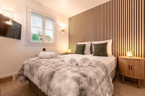 En eller flere senge i et værelse på 11 Terra Bella - Appt Climatisé