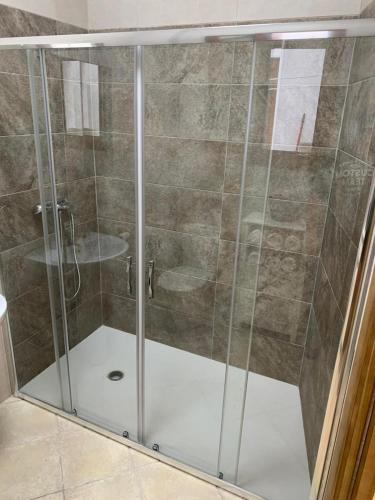 a shower with a glass door in a bathroom at Apartamento centro ciudad in Algeciras