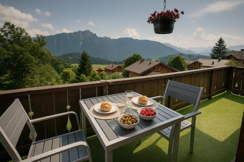 a table with bowls of food on a balcony at Chalet 6 personnes avec sauna in Leysin