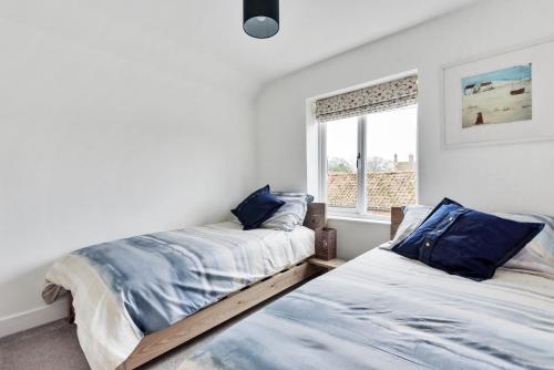 ein Schlafzimmer mit zwei Betten und einem Fenster in der Unterkunft 1 Crarves in Docking