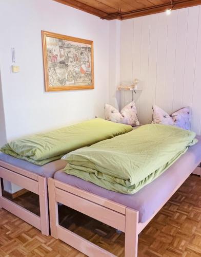 a bedroom with a large bed with two twin beds at Chasina Rosa in Scuol