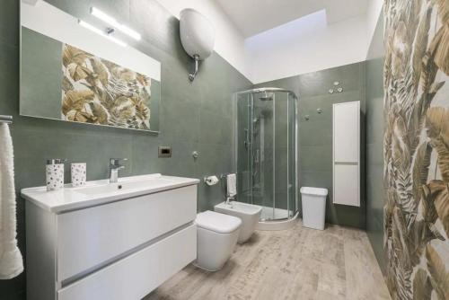 a bathroom with a sink and a toilet and a shower at Fichi d'India Appartamenti in San Pietro in Bevagna