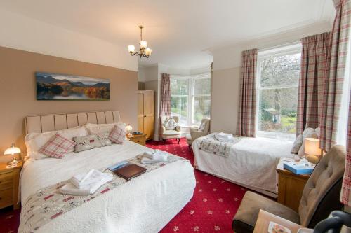 a bedroom with two beds and a window at Laurel Bank Guest House in Keswick