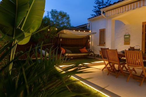 a patio with a table and chairs and a tent at BuzzStays: 1-Bed Bungalow, Garden, Near Yumbo & Beach in Maspalomas