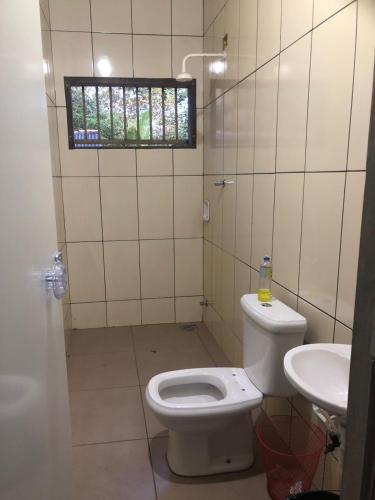a bathroom with a toilet and a sink at Chácara Maranata in Manaus