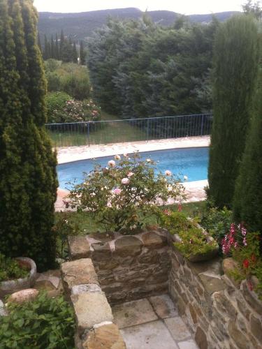 a view of a swimming pool in a garden at La Grange in Cruis