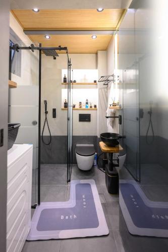 a bathroom with a shower with a toilet and a sink at Lussuoso Casa 2 in Patra