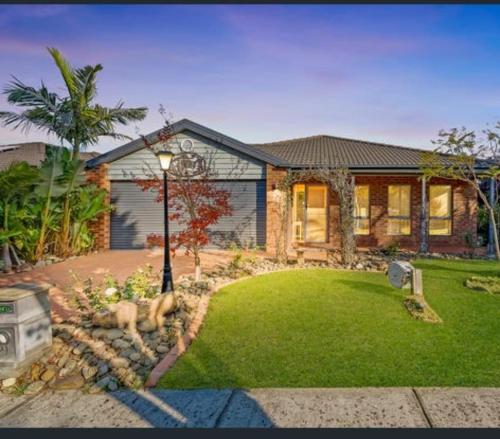 a house with a street light in front of a yard at 4 bedroom house in Berwick springs in Narre Warren South