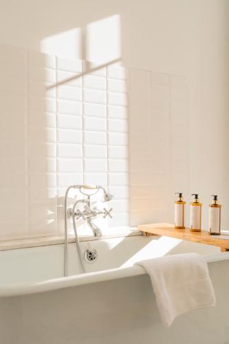 a bathtub with three bottles of essential oils on it at U Fiordalisu in Bastelica