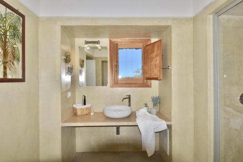 a bathroom with a sink and a mirror at Dammusi Sciuvechi in Pantelleria