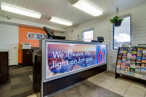 a large tv in a room with a sign on it at Motel 6 Eloy Arizona Casa Grande in Eloy
