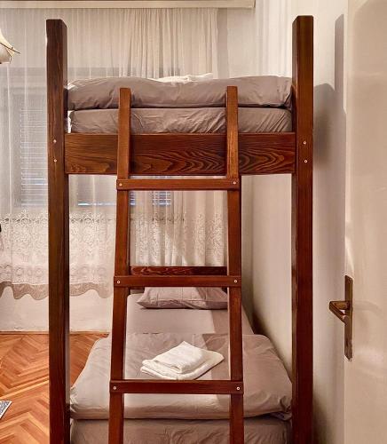 two bunk beds in a room with a window at Small Hill Guesthouse in Podgorica