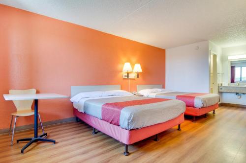 a hotel room with two beds and a table at Motel 6 Eloy Arizona Casa Grande in Eloy
