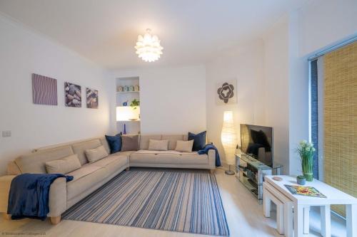 a living room with a couch and a tv at Stones Throw in Woolacombe
