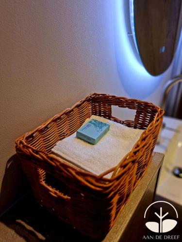 a basket with a book on top of a table at aan de Dreef in Zundert