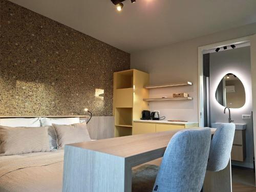 a bedroom with a bed and a table and chairs at aan de Dreef in Zundert