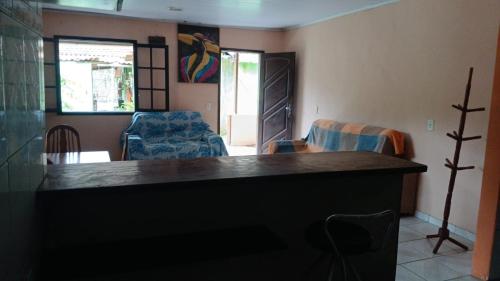 a living room with a table and two chairs at SacodoCeu2026 in Angra dos Reis