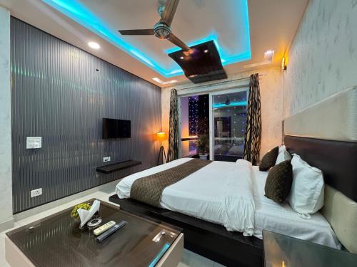 a hotel room with a bed and a tv at Sky Light Inn Hotel in Gurgaon