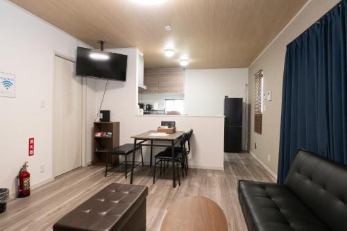 a living room with a couch and a table in a room at FabulousOdawara in Odawara
