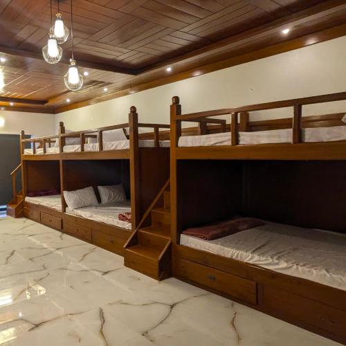 a room with three bunk beds in it at AlFalah Guest House in Murree