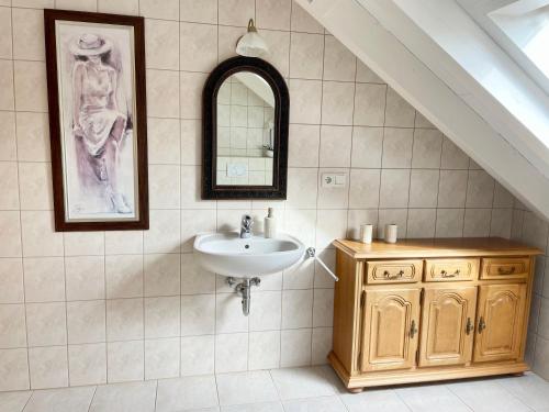 a bathroom with a sink and a mirror at Gästewohnung auf Gold's Obsthof in Karlburg