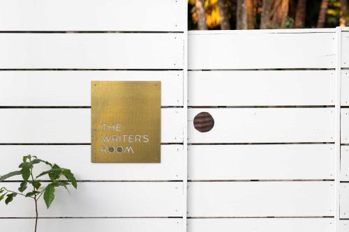 a sign on a white wooden wall at Romantic Escape l Firepit & Views l Nova Escapes in Goonengerry