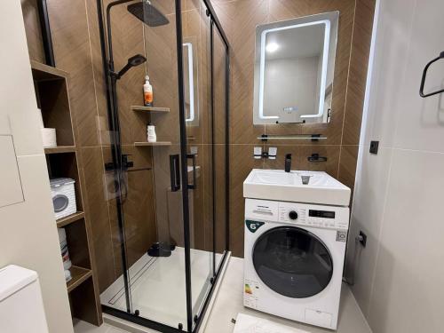 a bathroom with a washing machine and a sink at Modern spaces 12 in Yunusobod