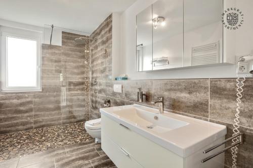 a bathroom with a sink and a toilet at ! NEU ! Markgraf Premium Apartments - Bad Bellingen in Bad Bellingen