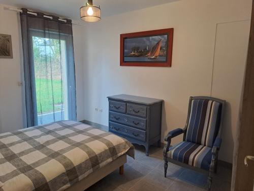 a bedroom with a bed and a dresser and a chair at Kerhuella in Saint-Ségal